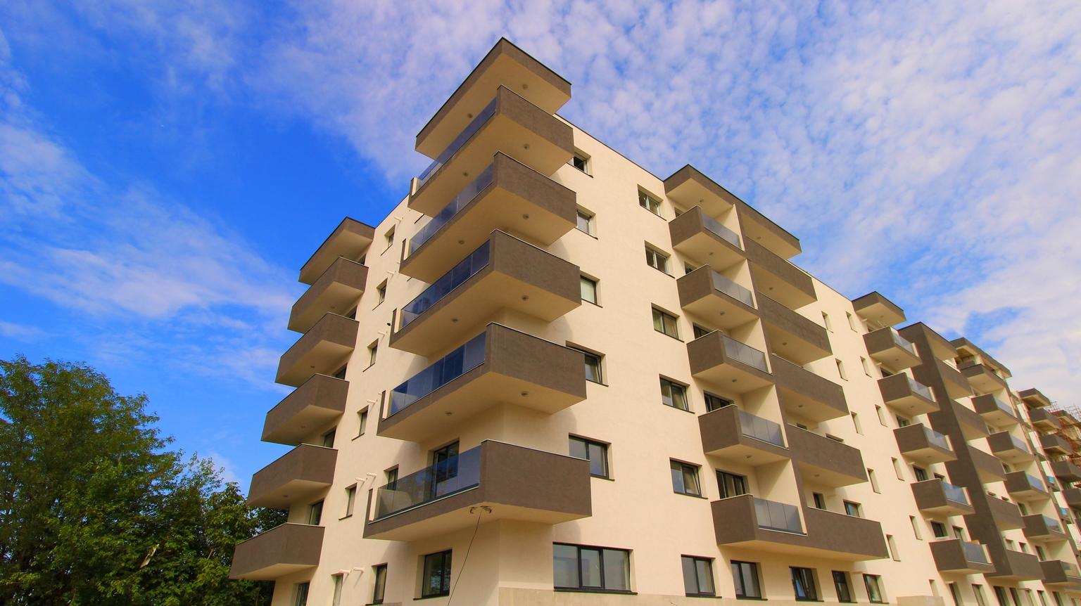 Two each of gray, white, and black shirts laying flat.